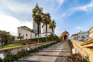 an old church with palm trees in front of it at Elm Alley Apartment - Baveno - Free Wi-Fi in Baveno