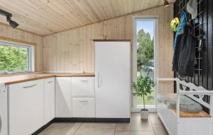 a kitchen with white cabinets and a door at 1 Bedroom Amazing Home In Gedser in Gedser