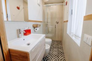 a bathroom with a white sink and a toilet at Luxury Chalet Liosa - Ski in Ski out - Amazing view in Corvara in Badia +32 photos