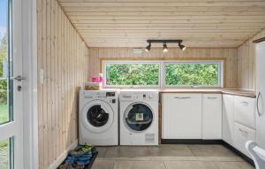 a laundry room with two washes and a window at 1 Bedroom Amazing Home In Gedser in Gedser