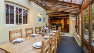 a long wooden table in a dining room at Coppice House in Ashton under Hill +23 photos