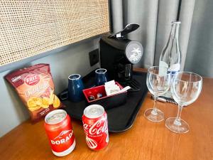a table with two cocacola cans and wine glasses at Coral Cotillo Beach in El Cotillo