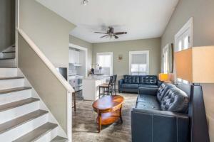 a living room with a couch and a stairway at The Collins on Duval in Key West