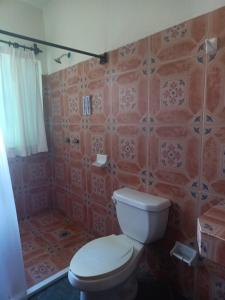 a bathroom with a toilet and a shower at HOTEL ATLANTIDA in Playa del Carmen