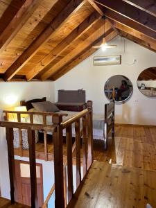 a room with a loft with a bed and a mirror at Aeneo Studio 1 in Symi
