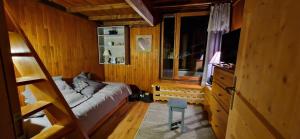 a bedroom with a bed and a television in it at Duplex à la Moutière in Tignes