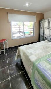 a bedroom with a bed and a window and a table at LaChula Casa con Piscina in Federación +9 photos
