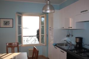 a kitchen with a sink and a window at Appartamento De Angeli in Laveno-Mombello