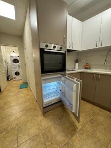 a kitchen with an open refrigerator and a sink at habitat Heart of Ruse Apartment in Ruse +25 photos