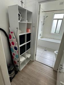 a bathroom with a walk in shower and a white cabinet at Spacious Family Home Sleeps 8 in South Grafton