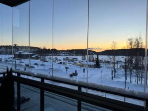 a view of a snow covered field from a building at Saunallinen Lutakon kaksio järvinäkymin in Jyväskylä