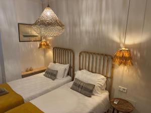 Postel nebo postele na pokoji v ubytování Appartement NoBe Es Pujols proche plage, vue mer
