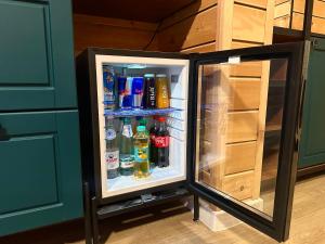 a refrigerator with its door open in a kitchen at Eastwood Hotel & Resort in Semey