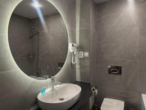 a bathroom with a sink and a mirror at Eastwood Hotel & Resort in Semey +29 photos