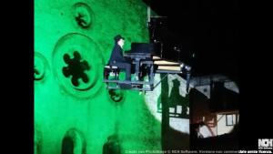 a man is climbing up a green wall at B&B La Dimora di Gioacchino in San Giovanni in Fiore