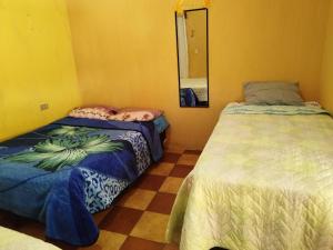 a room with two beds and a mirror at CASA BELINDA in Santiago Atitlán +7 photos