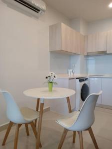 a kitchen with a table and two chairs at MC homes in Kota Kinabalu