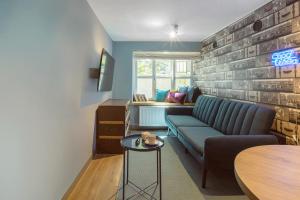 a living room with a couch and a table at Jana Apartment in Krakow