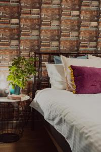 a bedroom with a bed and a wall of books at Jana Apartments in Kraków