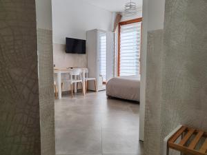 a bedroom with a bed and a table and a desk at Casalmare Sabina in Ventimiglia