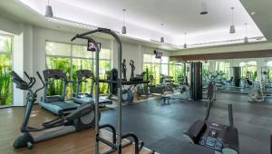 a gym with treadmills and elliptical machines at Mareazul Playa del Carmen in Playa del Carmen
