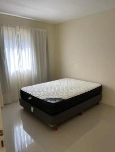 a bed sitting in a room in a bedroom at Chalet Sebastian II in Pinamar