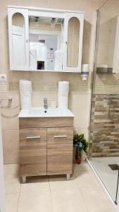a bathroom with a sink and a shower at Apartamentos Costavigia -Mar de Dunas- in Mazagón +57 photos