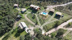 an aerial view of a house with a train at Chalés Vila Real - Tranquilidade na Serra de Carrancas - Piscina com uma vista espetacular do Pôr do Sol in Carrancas