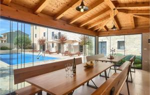 a dining room with a table and a pool at Villa Simeanna in Kringa