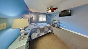 a bedroom with a bed and a ceiling fan at Put-in-Bay Waterfront Condo #107 in Put-in-Bay