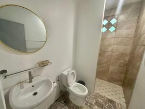 a bathroom with a sink and a toilet and a mirror at Kohchang stayin premium hotel in beach street market in Ko Chang