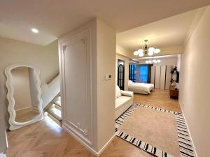a living room with a hallway with a door to a bedroom at ZHome-FuDi Garden-Near the Bund in Shanghai