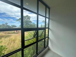 an empty room with a window looking out at a field at Kohchang stayin premium hotel in beach street market in Ko Chang