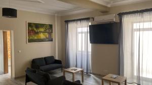 a living room with a couch and a chair at Acacias Rubras in Ferreira do Zêzere