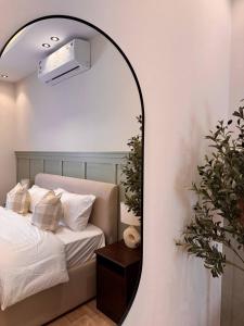 een spiegel in een slaapkamer met een bed en een bed. bij غرفة على الطراز الريفي in Riyad