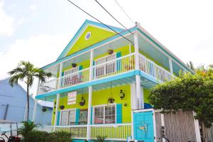 a yellow and blue house with a balcony at Caribbean House in Key West