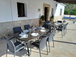 a group of tables and chairs on a patio at Casa La Fuente in El Chorro +46 photos