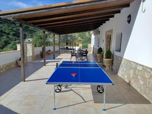 two ping pong tables on a patio at Casa La Fuente in El Chorro