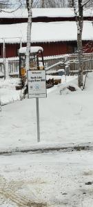 a sign in the snow in front of a building at North Lakes Eagle River B&B in Eagle River