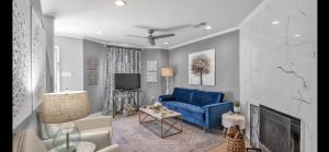 un soggiorno con un divano blu e una TV di Elegant condo Two ensuite baths with gourmet kitchen near Mall of LA & LSU Top restaurant venues a Baton Rouge