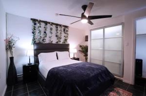 a bedroom with a bed and a ceiling fan at City Gem in Long Island City