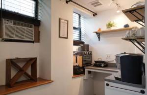 a kitchen with a stove and a microwave in a room at City Gem in Long Island City