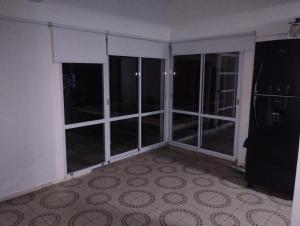 an empty room with large glass windows in a room at Casa de Fin de semana in María Grande +15 photos