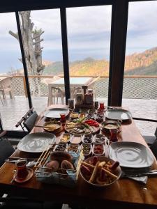 a table with plates of food on it at Pagen Bungalow in Hopa