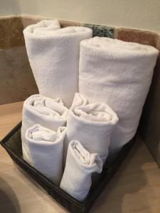 a tray of white towels on a table at Vip Bergamo Apartments in Bergamo