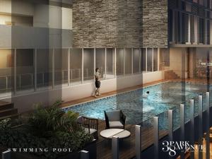 a woman is standing next to a swimming pool at ARC Studio Unit at 38th Park in Cebu City