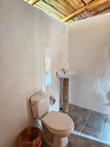 a bathroom with a toilet and a sink at Estadero Los hoyos in Villavieja +51 photos