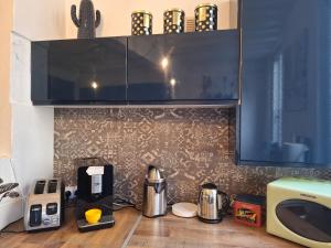 a kitchen counter with a coffee maker and a microwave at Maison hypercentre Rouen tout confort in Rouen