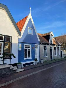 登霍伦Het Heertje的一条蓝色房子,在街上有橙色的屋顶