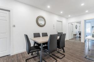 a dining room with a table and black chairs at Huge 3 Bedroom Condo with a Large Patio in Montréal +11 photos